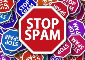 Central red stop sign reading STOP SPAM surrounded by colorful STOP SPAM signs.