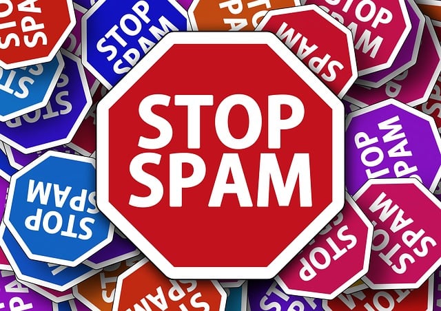 Central red stop sign reading STOP SPAM surrounded by colorful STOP SPAM signs.