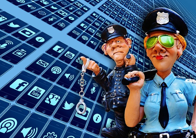 Two cartoon police officers stand in front of a wall of blue social media icons, symbolizing online security and monitoring.