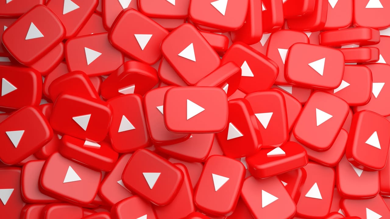 Pile of red square YouTube play button icons with white triangles filling the frame.